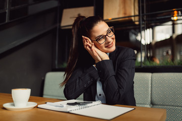 Happy businesswoman looking at side. Girl dreaming about something beautiful with smile on her face.