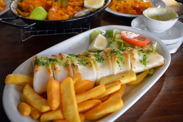Grilled calamari, vegetables and french fries. Close up.