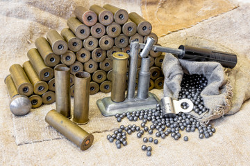 hunting equipment on the background of an old sacking. Brass shells, hunting shot concept as...