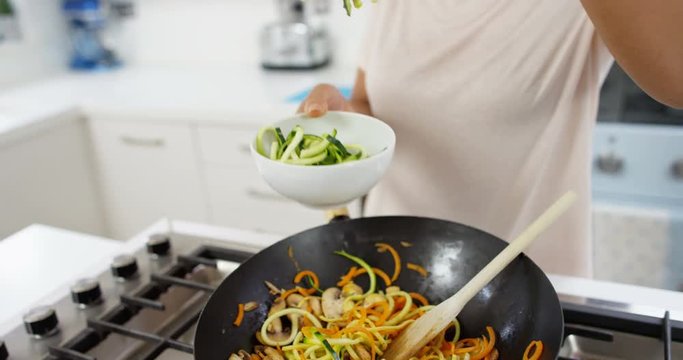 4K Woman cooking a healthy meal for modern TV cookery show or internet vlog, with hand held camera work & close ups