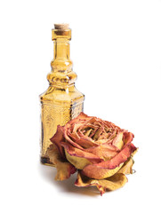 Bottle with aromatic oil and roses. Isolated on white background