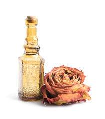 Bottle with aromatic oil and roses. Isolated on white background