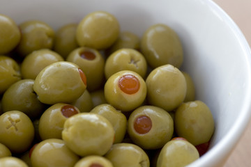 Pimento stuffed green olives in a white bowl