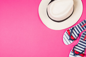 Woman's accessories lying flat on pink paper table background. Pastel colors with copy space around products . Image taken from above, top view. Minimal style with room for text