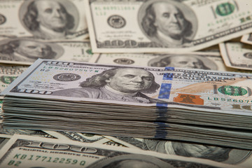 stack of dollars against the backdrop of money
