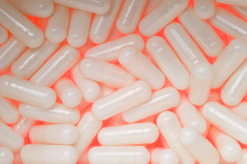 Backlit Glucosamine Sulphate capsules glowing close up