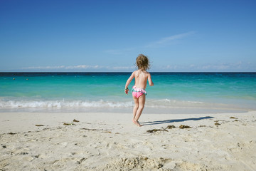 Child playing on a caribbean beach