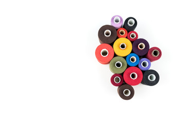 Set of coloured thread coils on white background, sewing and tailoring