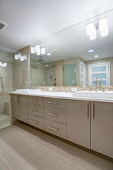 Modern refreshing bathroom with a beige dual washstand.