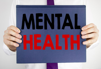 Writing text showing Mental Health. Business concept for Anxiety Illness Disorder written on book...