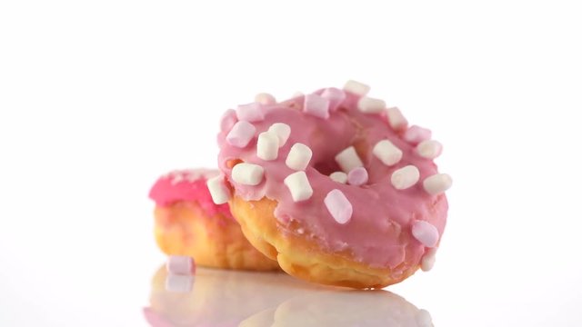 Donut. Sweet glazed pink donuts rotated on white background. 4K UHD video footage. 3840X2160