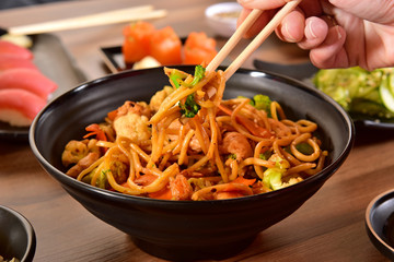 Chopsticks holding chinese noddles