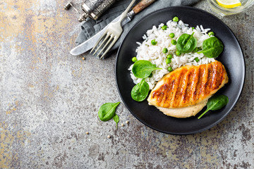 Chicken breast or fillet, poultry meat grilled and boiled white rice with green peas and fresh...