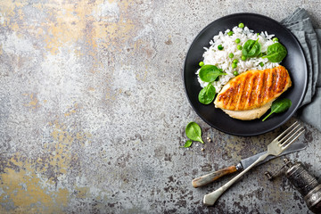 Chicken breast or fillet, poultry meat grilled and boiled white rice with green peas and fresh...