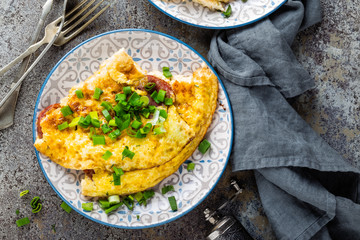 Omelet or omelette with fresh green onion, scrambled eggs - obrazy, fototapety, plakaty
