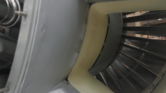 The side view of structure of the aircraft engine. There are lots of pipes, pumps, compressors, gears, pulleys, blades, valves, hydraulic and servo drives and other elements
