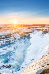 Winter sunrise above Gullfoss waterfall, in Iceland. Gullfoss is one of the most popular tourist...