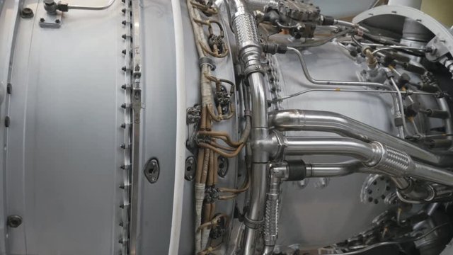 Turbine engine side view. Dismantled turbine of aircraft under repair in hangar

