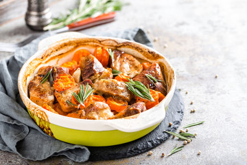 Meat baked with carrots in the oven