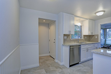 Photo of a small compact kitchen with white shaker cabinets