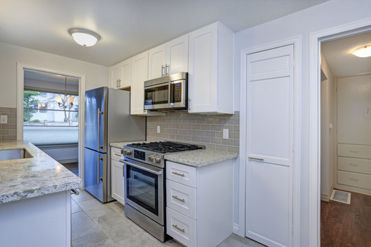 Photo Of A Small Compact Kitchen With White Shaker Cabinets