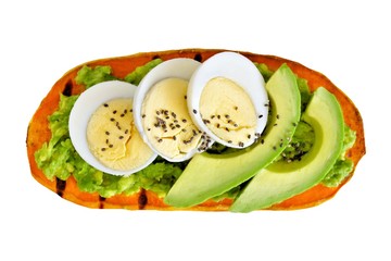 Sweet potato toast with avocado, eggs and chia seeds. Isolated on a white background.