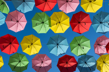 Fototapeta na wymiar Umbrellas against bright blue sky
