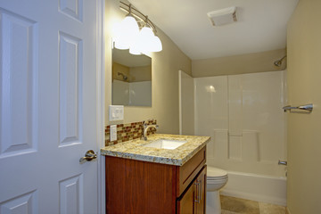 Stunning bathroom with mosaic tile backsplash.