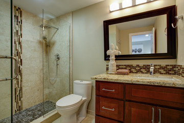 Elegant bathroom with a mahogany stained vanity
