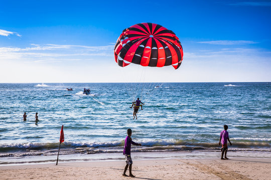 Tourists playing parasailing on Patong beach in Phuket ,Thailand.