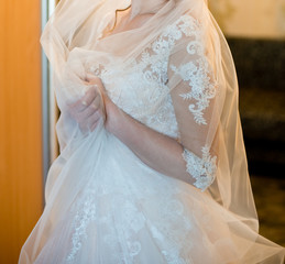 Morning of the bride. Beautiful bride getting dressed and preparing for the wedding