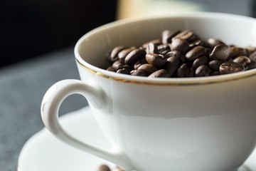 Cup with whole coffee beans