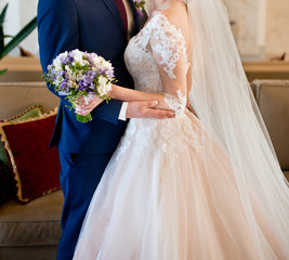 Young bride in wedding dress holding bouquet