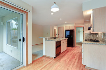 Large open kitchen with granite counter tops.
