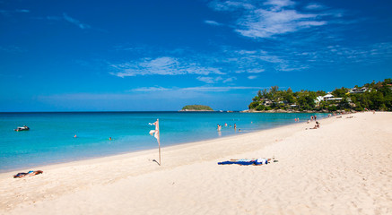 Unidentified people are relaxing on Kata beach in Phuket, Thailand.