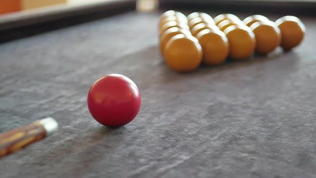 Man playing billiard, snooker. Player preparing to shoot, hitting the cue ball. A simple blow from close range.