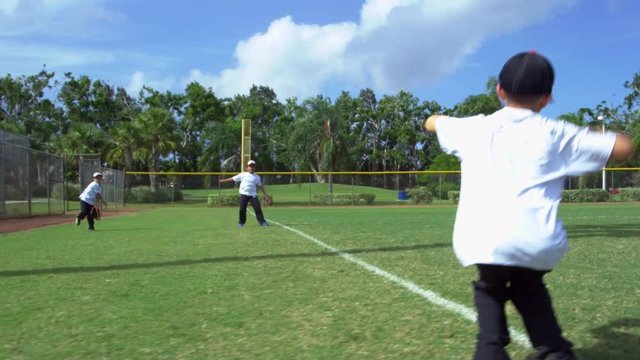 Great shot of kids throwing and catching during baseball practice 