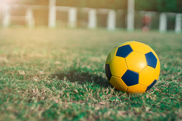 Fototapeta premium Soccer ball on grass in stadiums for sport.