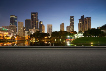 Fototapeta na wymiar Asphalt road side with beautiful Kuala Lumpur city waterfront skyline. Night scene .