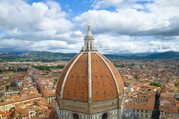 Dome of the ancient cathedral of Santa Maria del Fiore close-up under the cloudy September sky. Florence, Italy