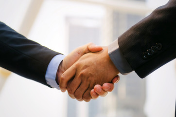 Welcome. Deal. close up of business man in suit handshake after finishing up a business meeting in the city, congratulation, success, meeting, partner, teamwork, community and connection concept