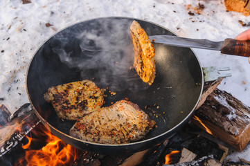 cooking meat on campfires in field conditions