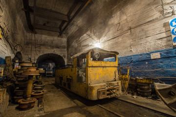 Fototapeta na wymiar Underground ore mine shaft tunnel gallery with electrical locomotive room
