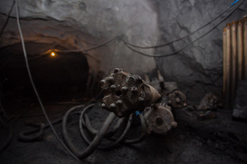 Underground iron ore mine shaft tunnel gallery with drilling machine