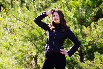 Young beautiful woman in the summer in the woods among the trees.