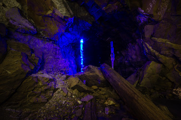 Underground abandoned gold ore mine shaft tunnel gallery with blue stagmites