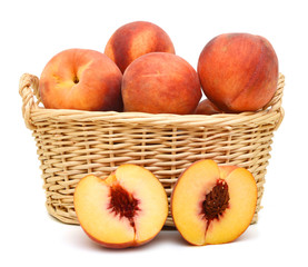 sweet peaches in basket on a white background