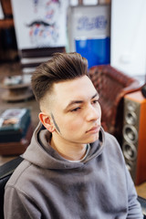male model shows a haircut in a barber shop