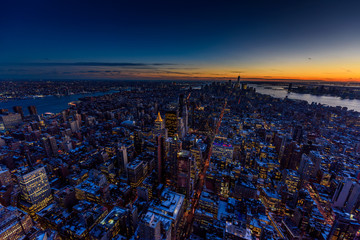 New York City - Manhattan downtown skyline skyscrapers at night - View from Observation Deck on the Empire State Building at twilight. USA.