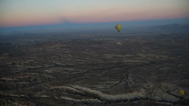 Hot air balloons flying over valley at sunrise. Cappadocia. Turkey